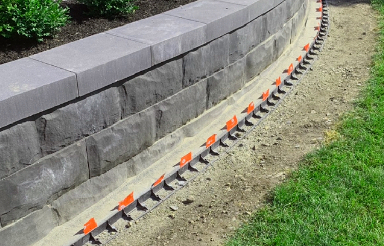 closeup of a rock wall and a small patch of grass on the right side